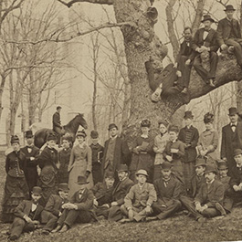 men and women posing on an oak tree