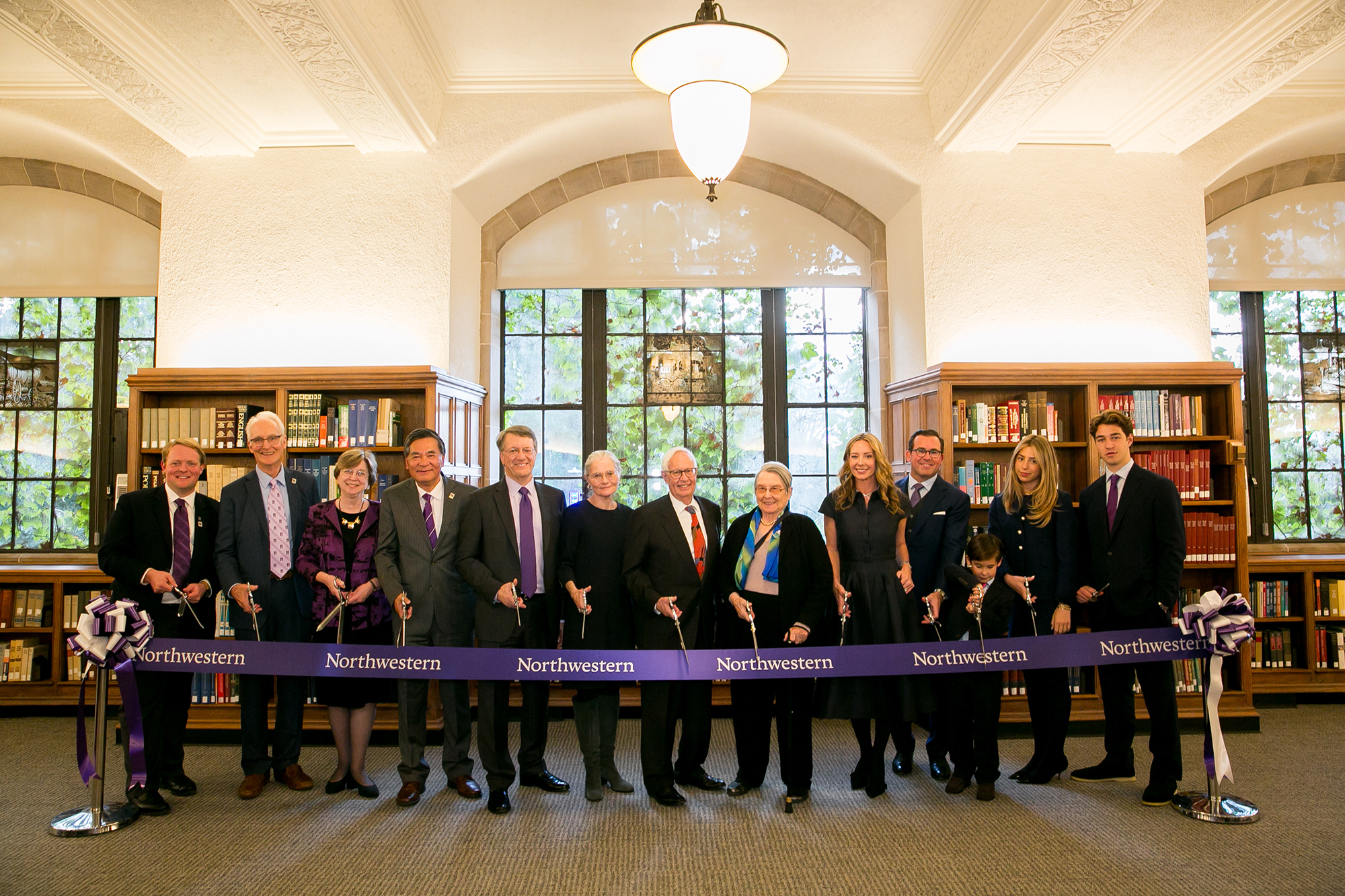 From left to right: Kammer Strachan ’17, Stephen M. Strachan (’17 P), dean of Libraries emeritus Sarah M. Pritchard, dean of Libraries Xuemao Wang, Board of Trustees chair Peter J. Barris ’74 (’11 P, ’18 P), provost Kathleen Hagerty, interim president Henry Bienen, Leigh Bienen, Nancy McCormick (’29 P), Ramon A. Rasco (’29 P), Charlie Rasco, Cyra Vella, and Sebastian Vella ’29.