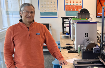 Portrait of Ted Quiballo surrounded by maker equipment