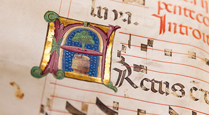 A closeup on an illuminated letter in a manuscript.